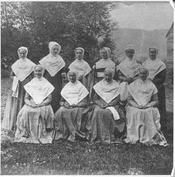 SA0162 - Ten Shaker sisters shown outside; some are seated. Taken from a stereograph., Winterthur Shaker Photograph and Post Card Collection 1851 to 1921c